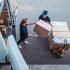 Delivery workers using a Hydraulic Hand Pallet Truck to load a delivery van.